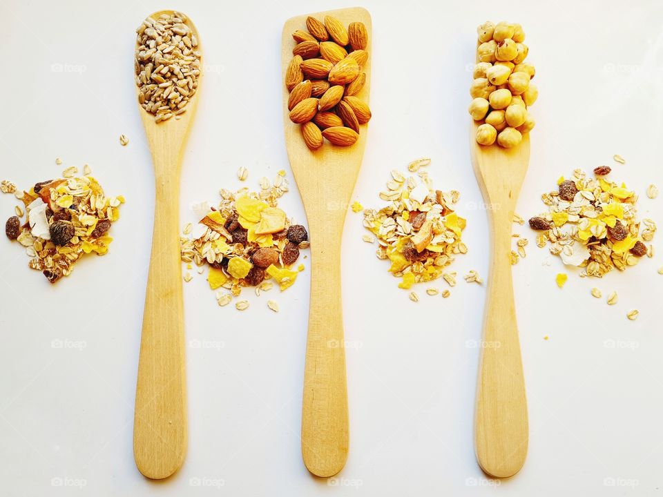 wooden ladles containing healthy nuts and seeds