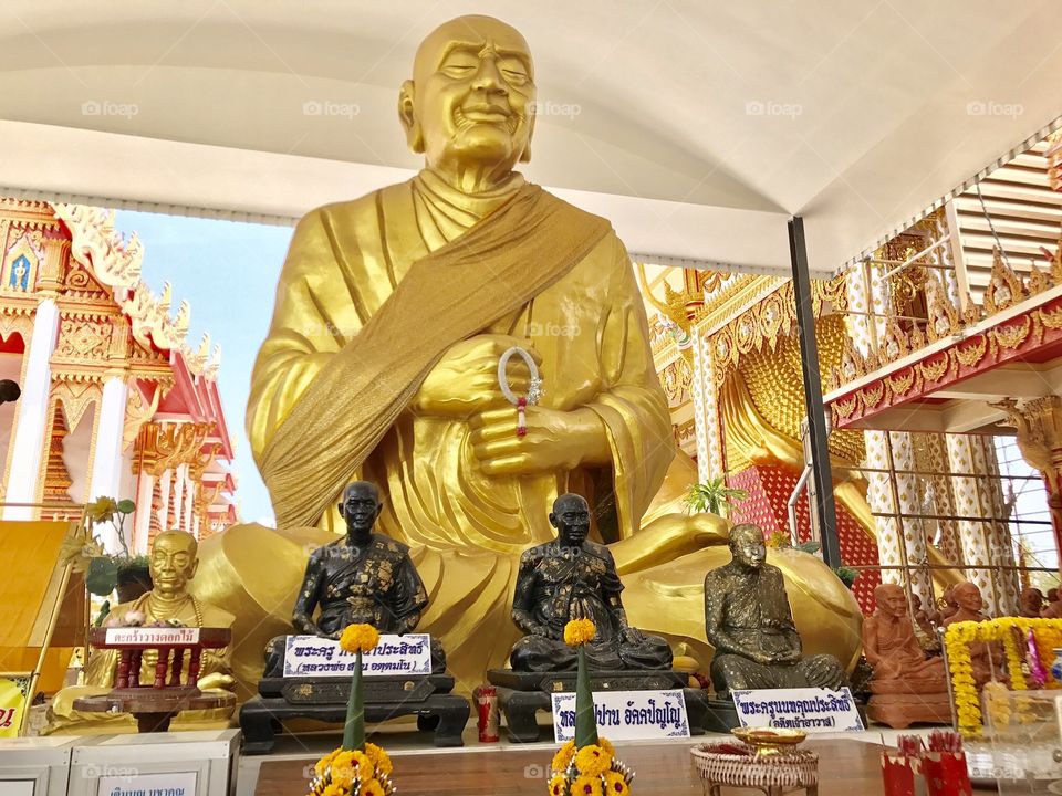 A big golden statue of a monk