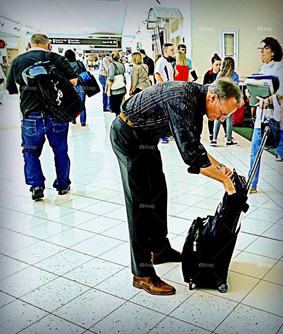 Airport traveler. People traveling through a busy airport.
