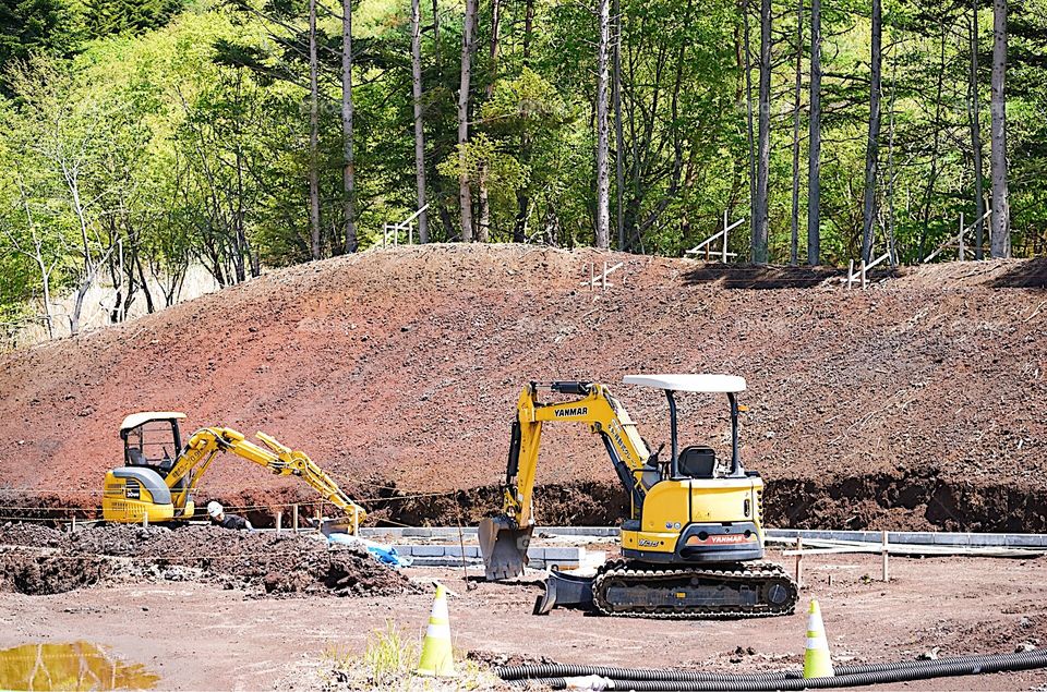 Construction car on restricted area site. A tractor on working site. Working under construction concept.