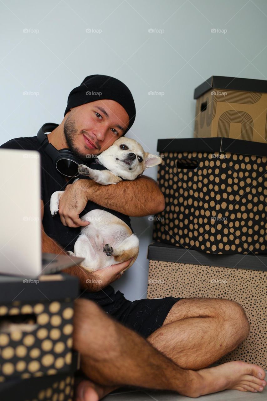 stylish guy in black clothes, with headphones and his best friend, a dog. a twenty-three-year-old teenager, a new generation.