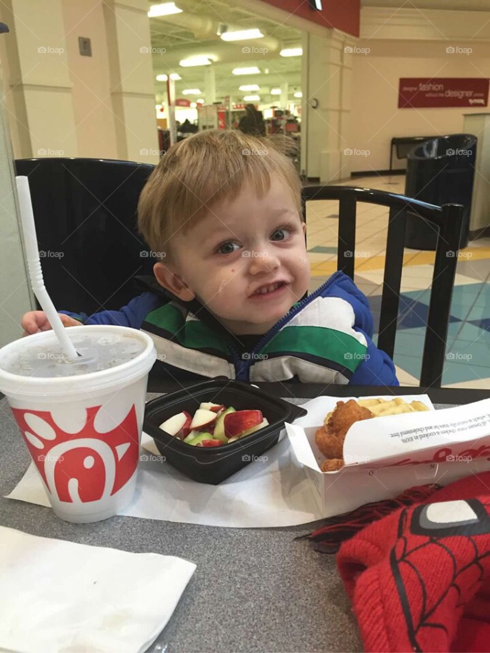 Portrait of a boy eating fruits in restaurant