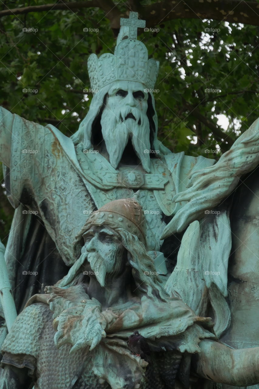 Front of the Notre Dame of Paris cathedral, detail view over the bronze statue installed on a pedestal, which represents Charlemagne on a horse, accompanied by his vassals Roland and Olivier