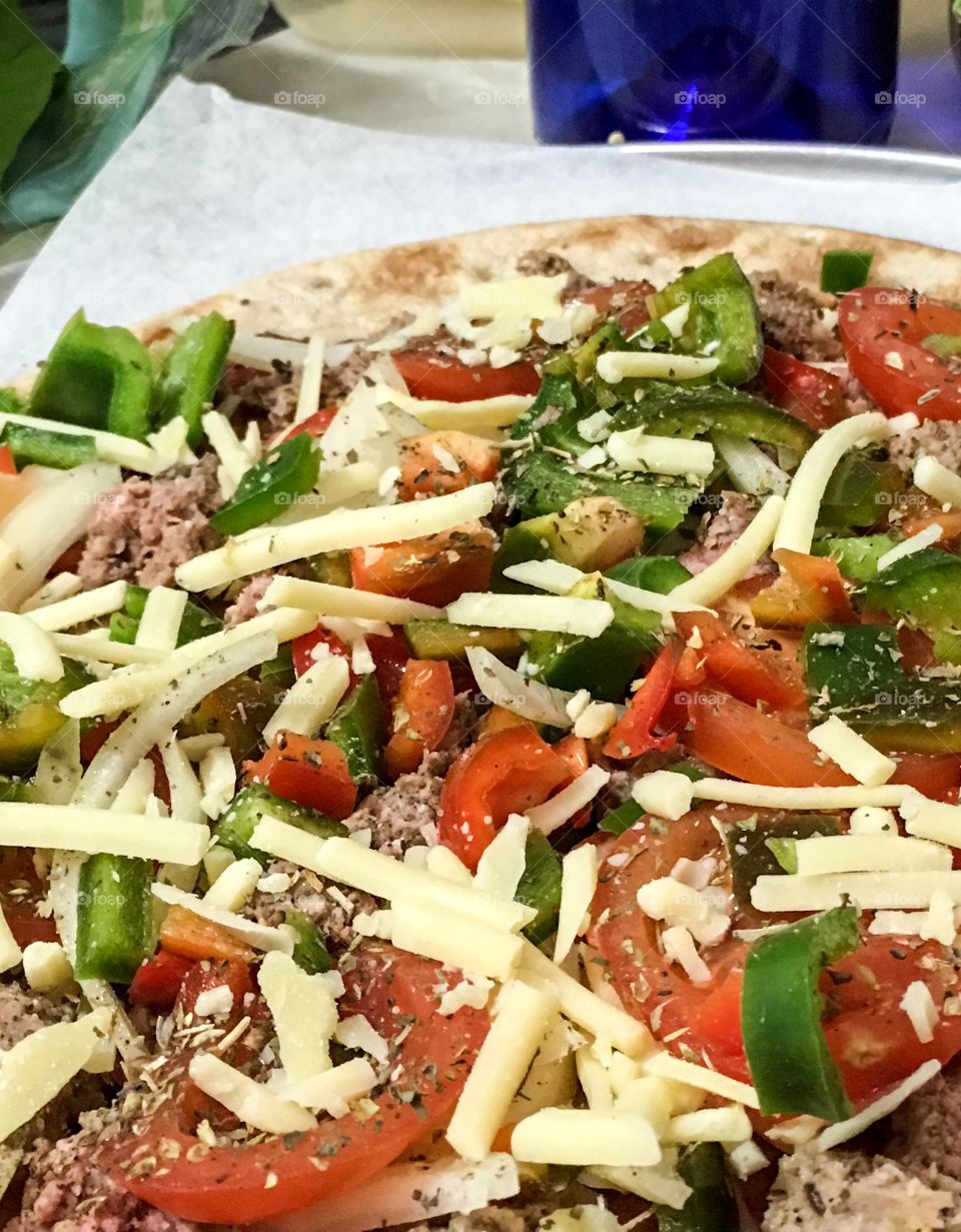 Homemade pizza topped with arugula (rocket)