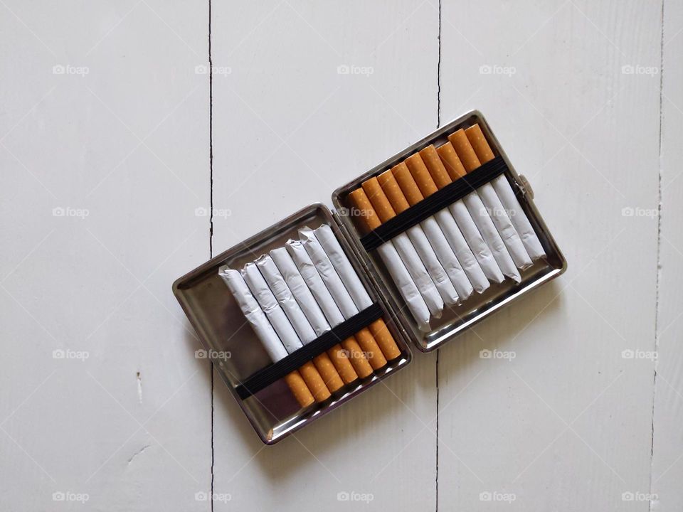 cigarette case with cigarettes on a white background