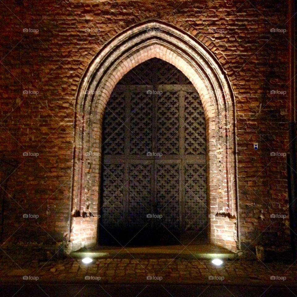 Gdansk at night. An old cathedral gate
