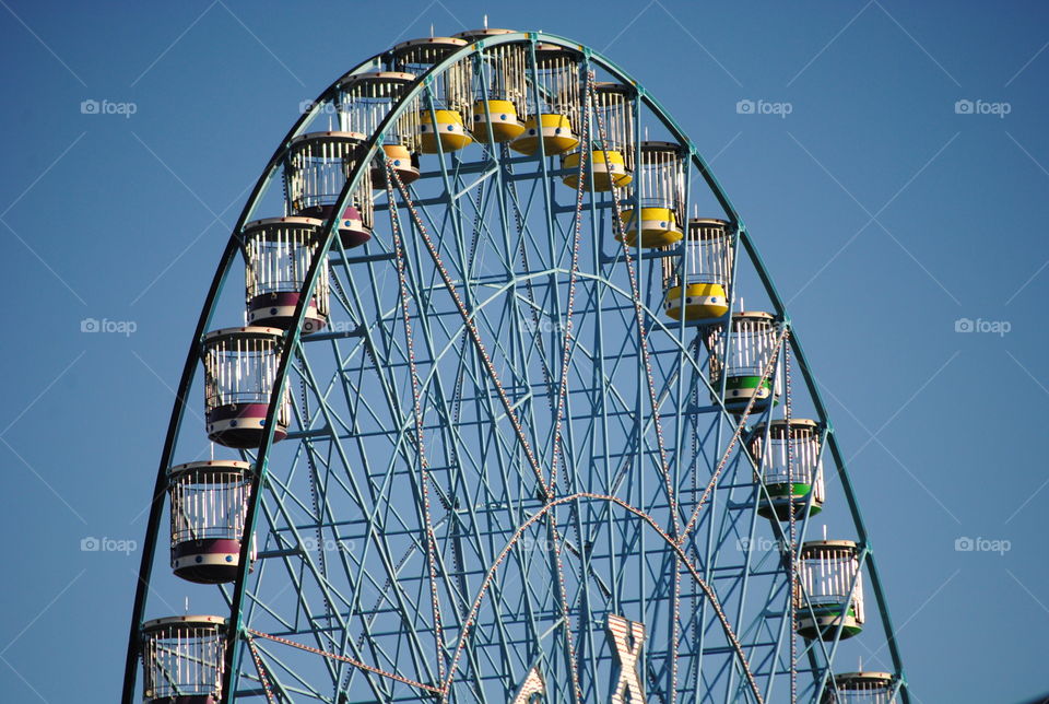 Ferris wheel against blue sky