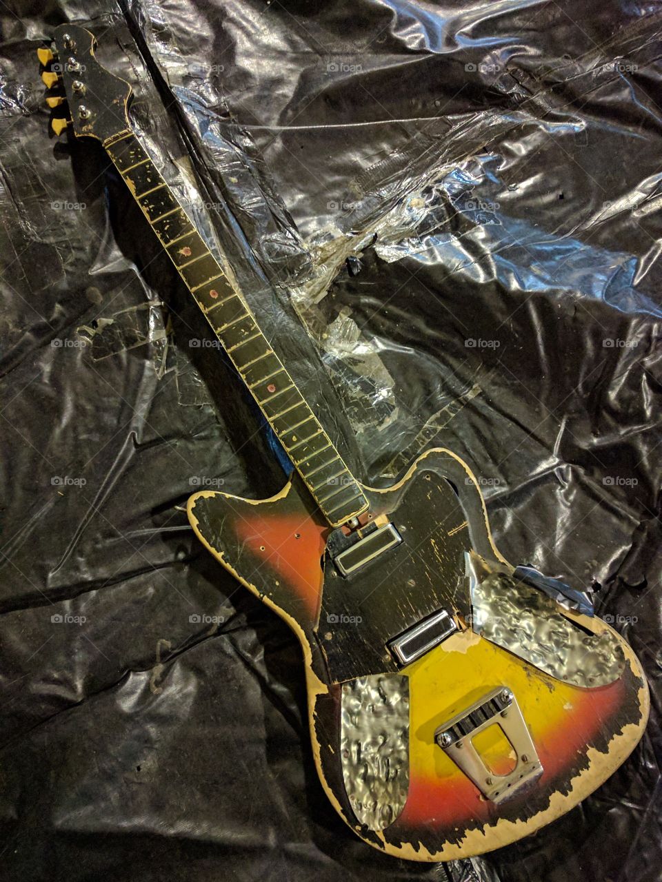 Old broken guitar on old broken vinyl
