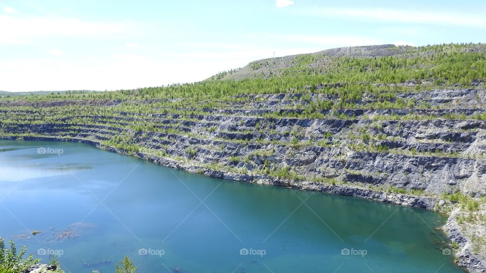 Groundwater in the quarry. 
The color of water is determined by minerals. Flooded areas of development Zavitinsk Deposit in the Zabaykalsky Krai.