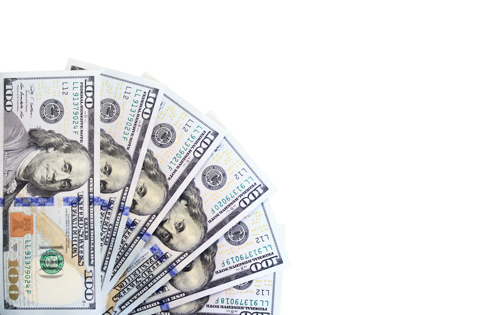 Dollars spread in a fan shape on a white background