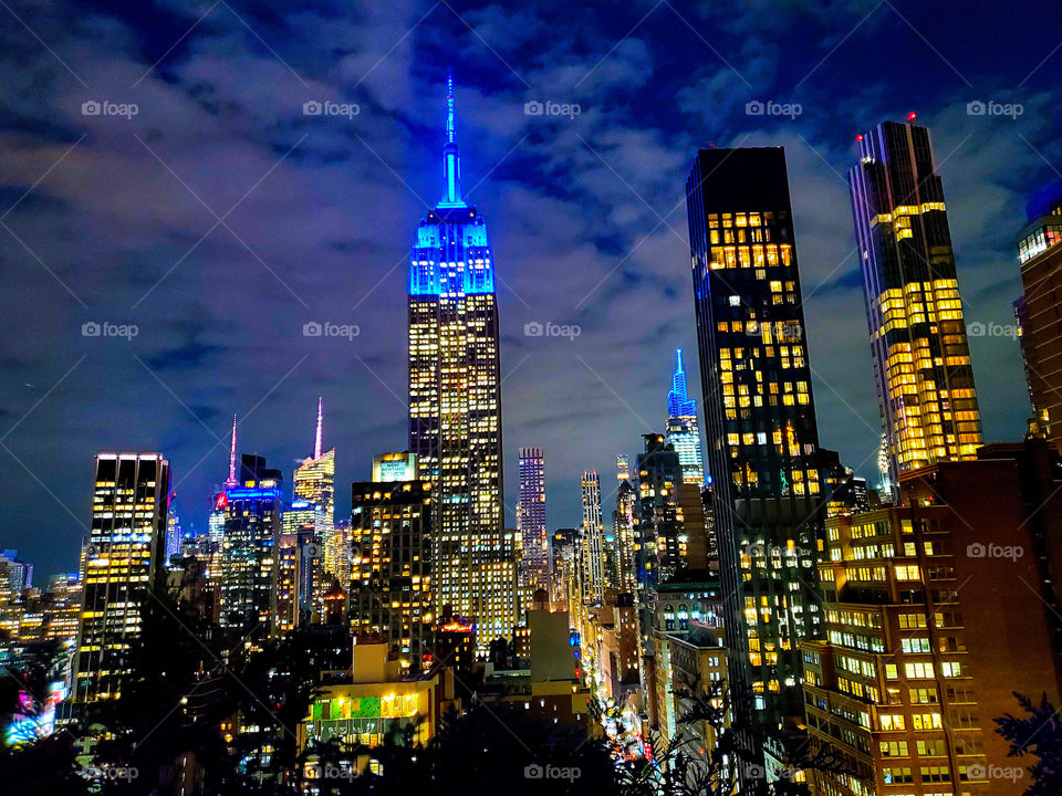 The iconic and world famous Empire State Building is bathed in blue light on a crisp fall night