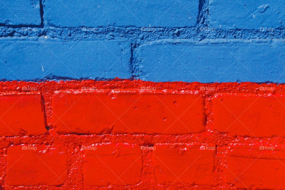 Painted red and blue bricks on a building in New York City.