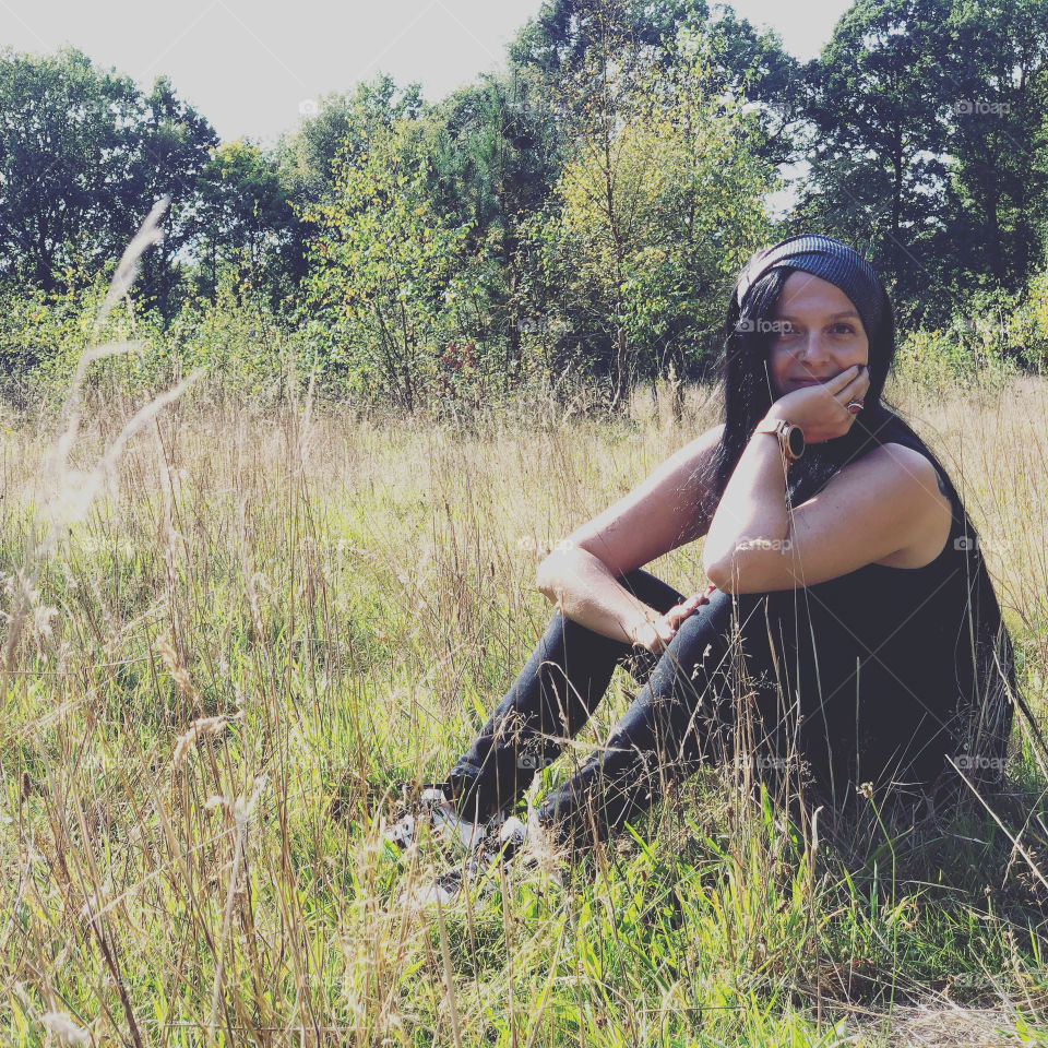  beautiful black haired woman enjoying the sun out in the woods