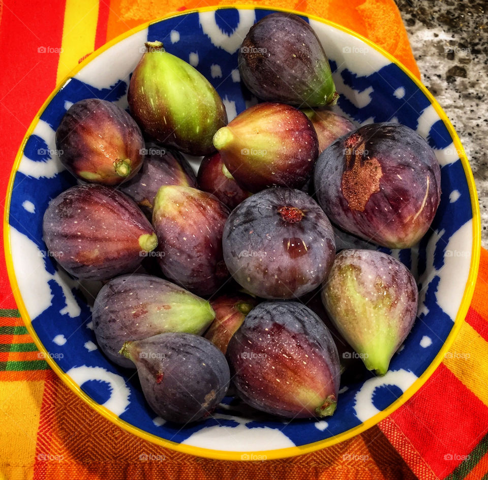 Bowl of black figs on a colorful tablecloth 
