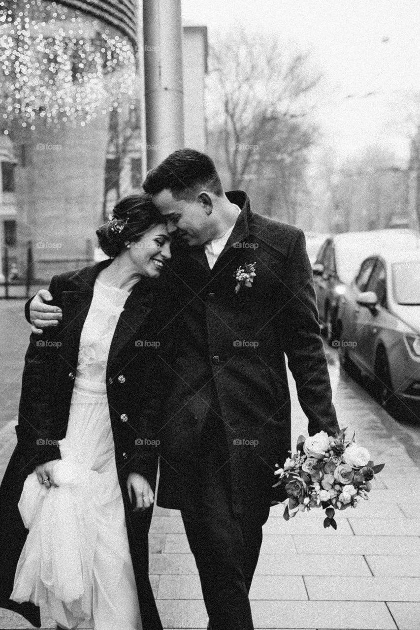 Bride and groom walking city