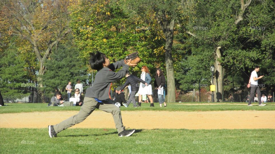Child Catching a Fly Baseball in the Park on a Nice Sunny Autumn Day