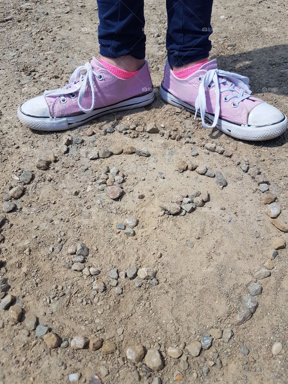 kid playing with rock on the playground