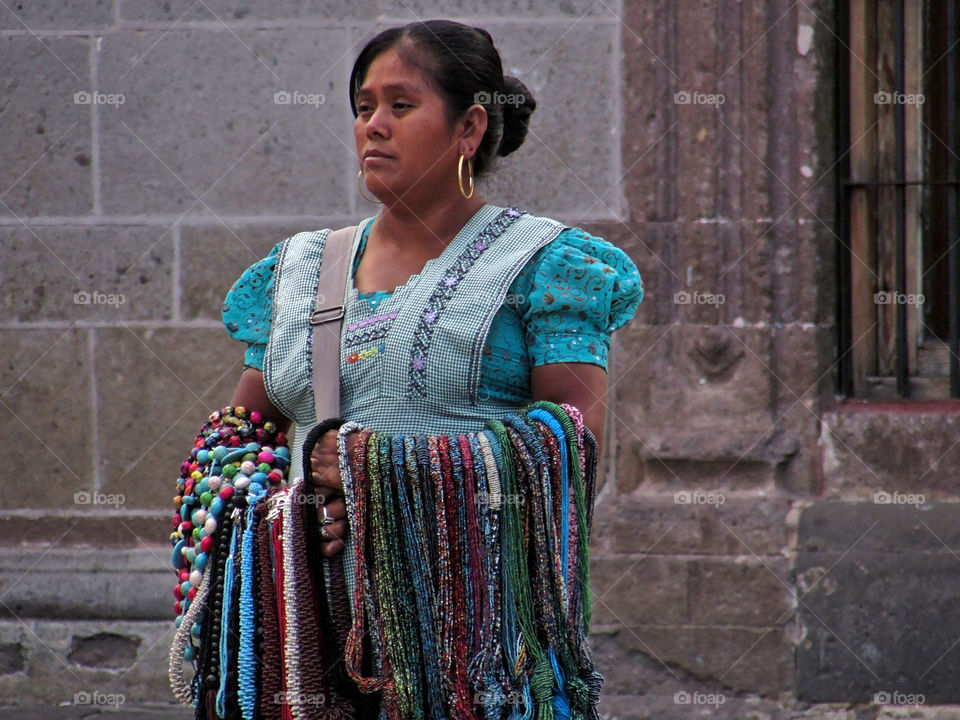 Indigenous mexican woman selling hand-crafted jewelry in the streets of San Miguel de Allende, Guanajuato, Mexico