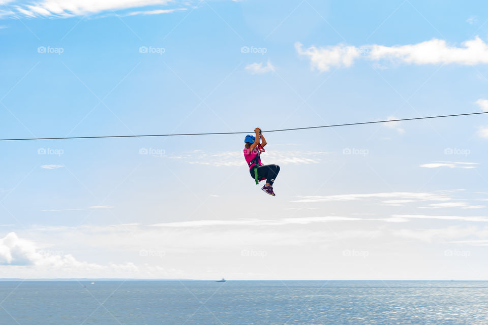 a girl sliding over the ocean