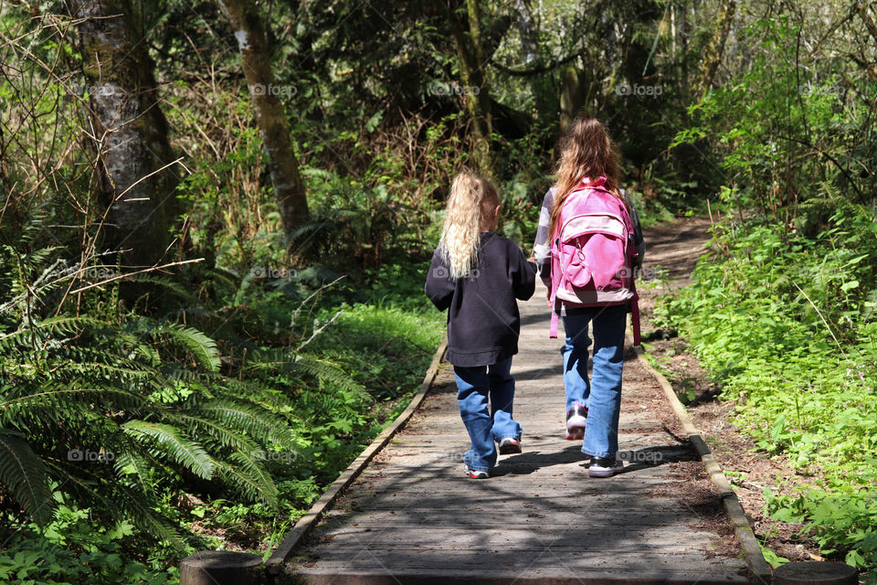 Sisters hiking through the forest