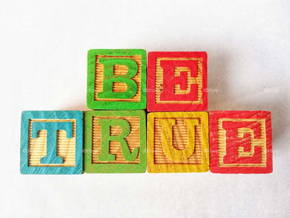 Written be true with wooden cubes