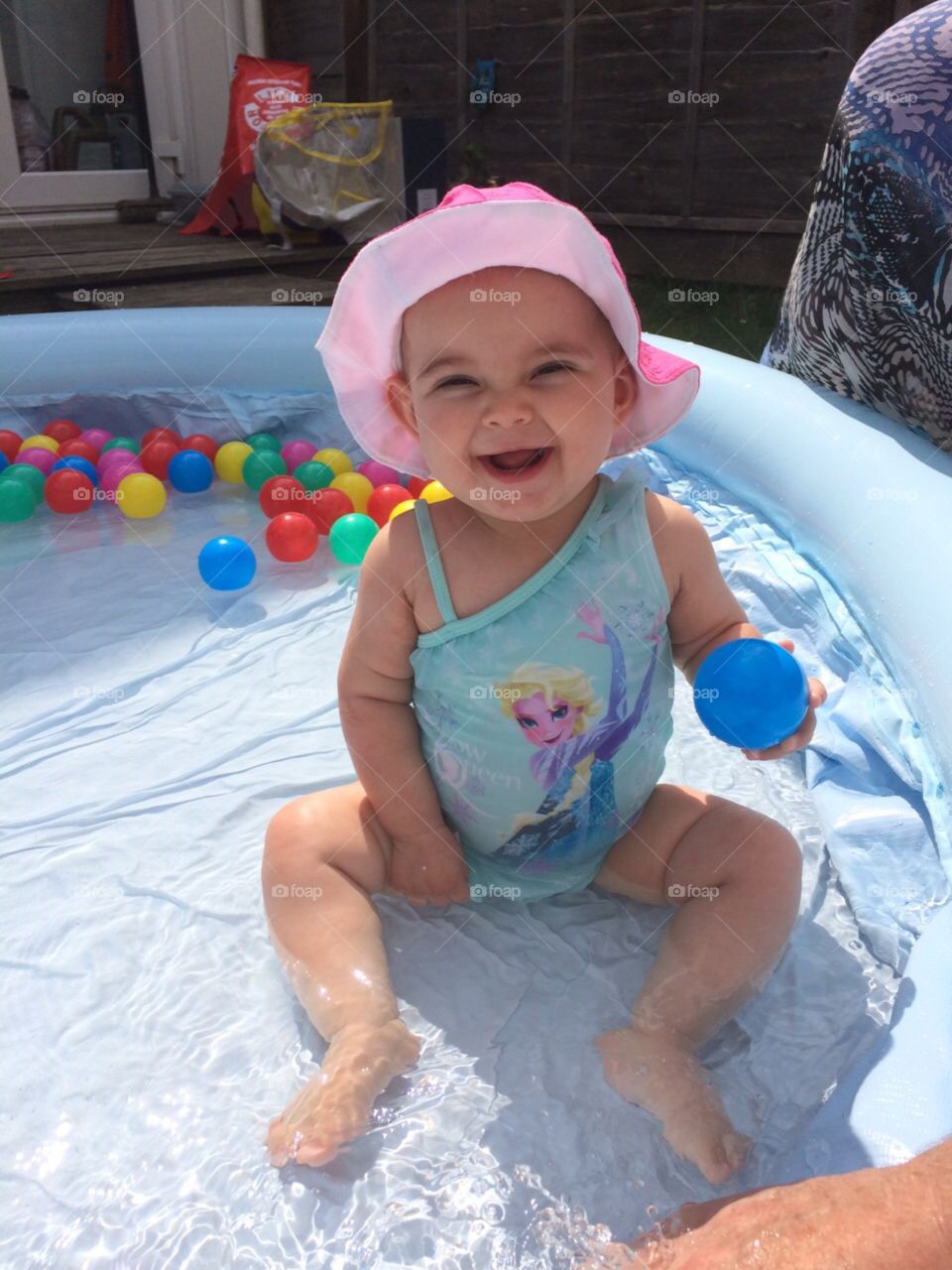 Swimming baby . My little girl playing in her first swimming pool and loving the water on a hot summers day 