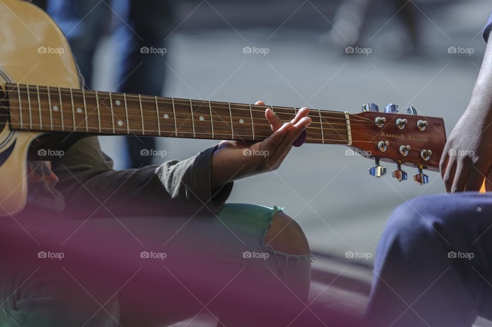 The guitar boy. Street photography Maboneng, South Africa.. Side walk guitar lessons for children from the community.