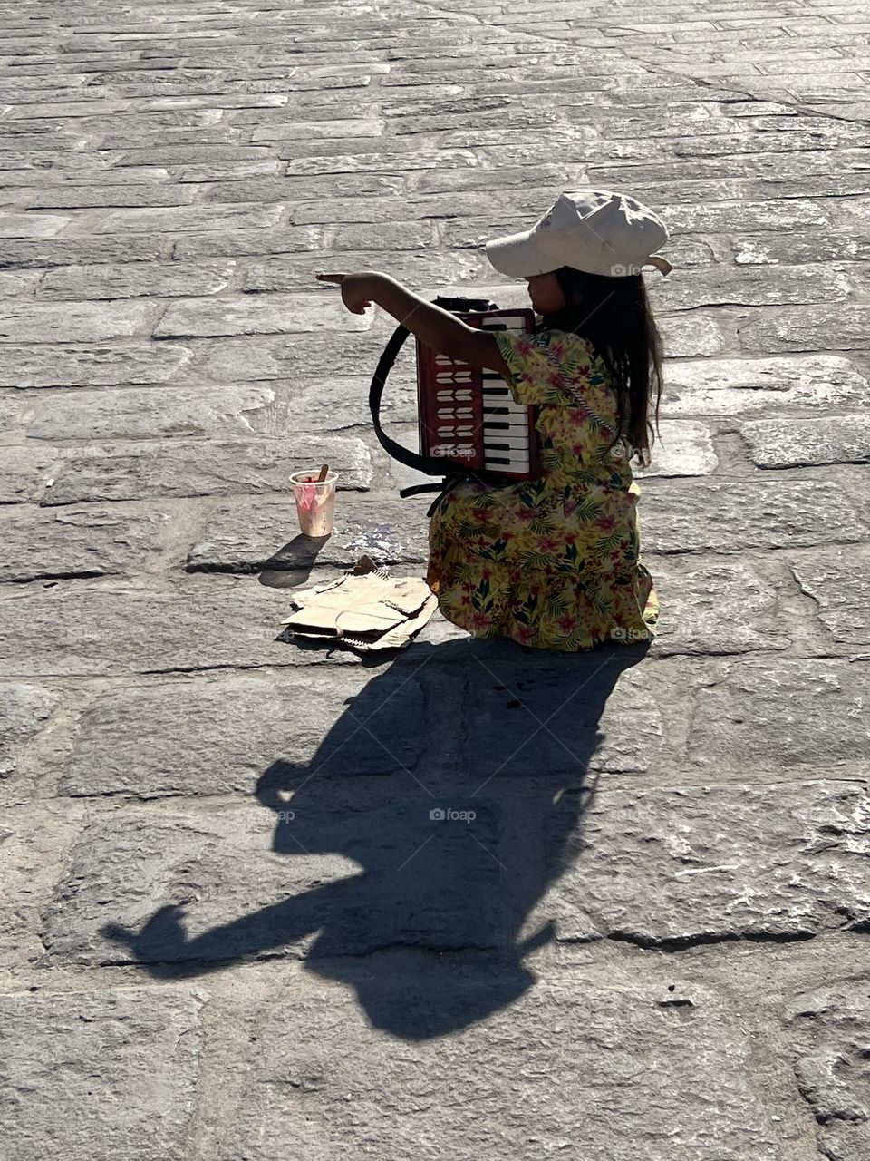 Girl playing accordion in the street 