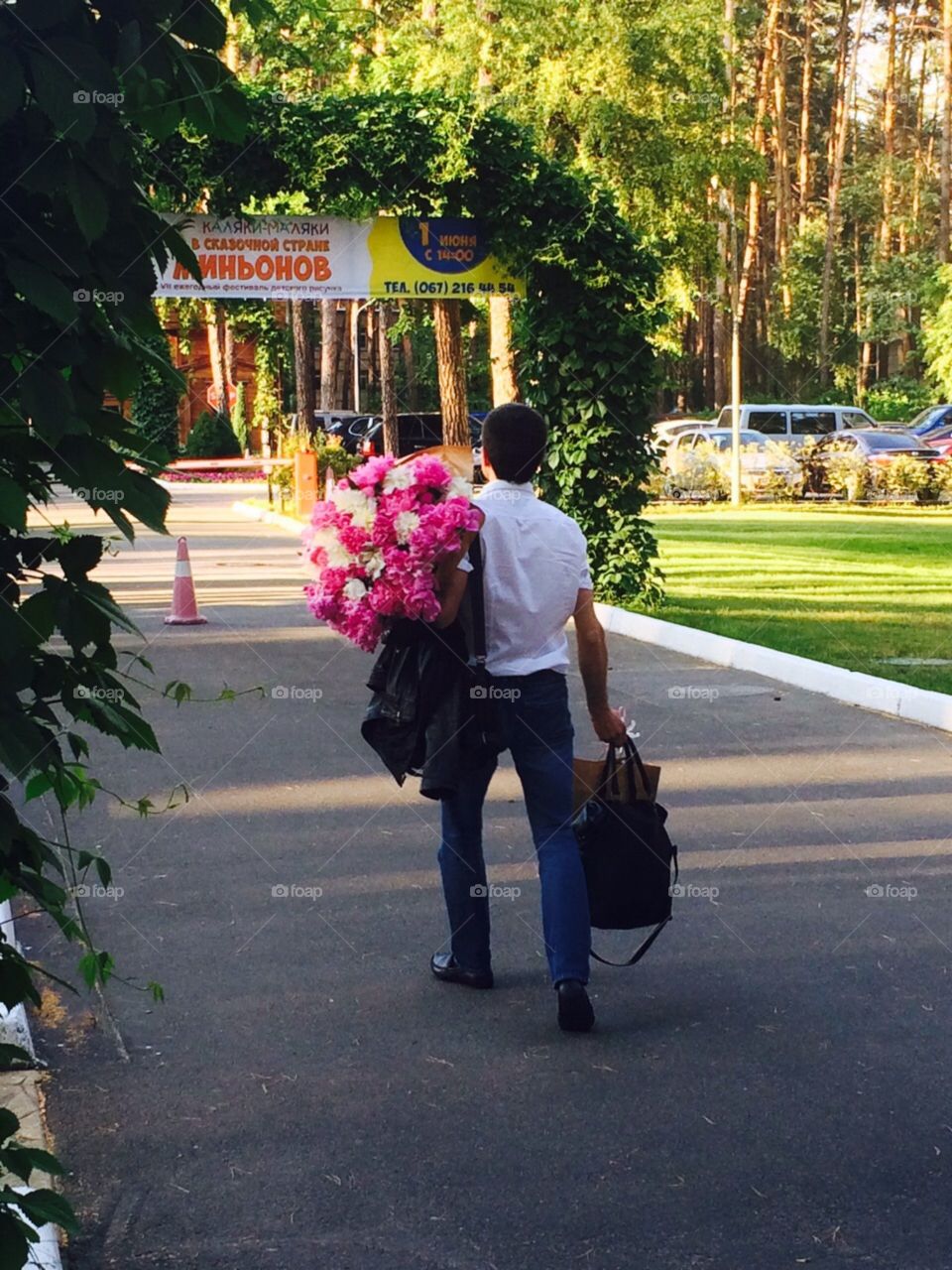 A man carrying flowers and bags