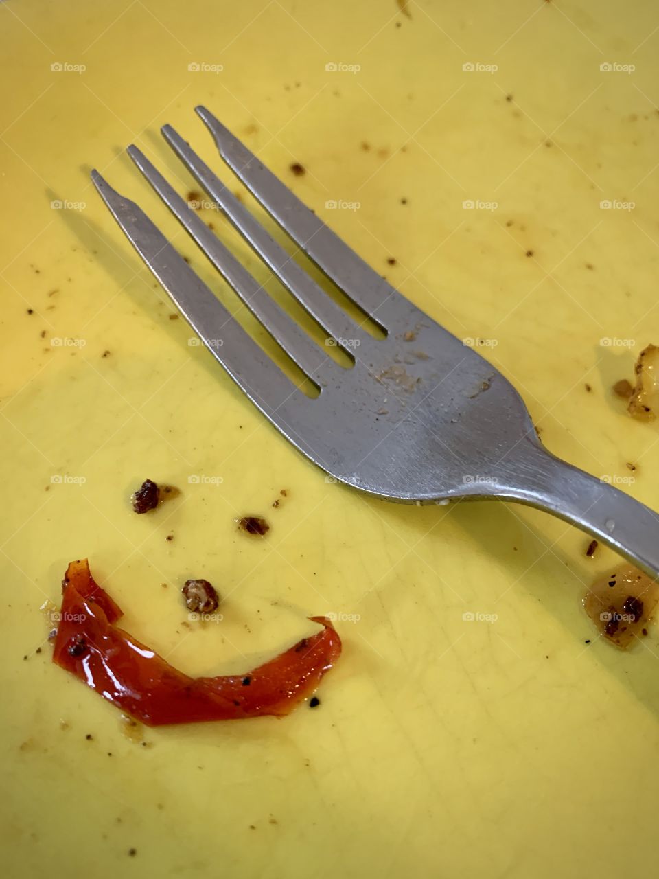 Fork, plate and happy face made of food