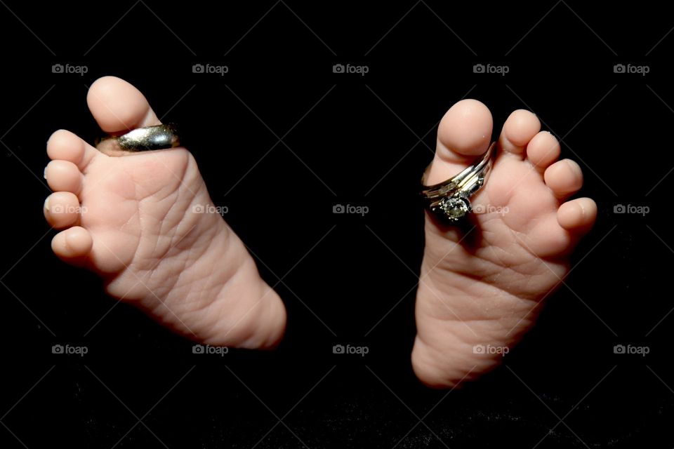 Mom and Dad’s wedding ring on infants feet