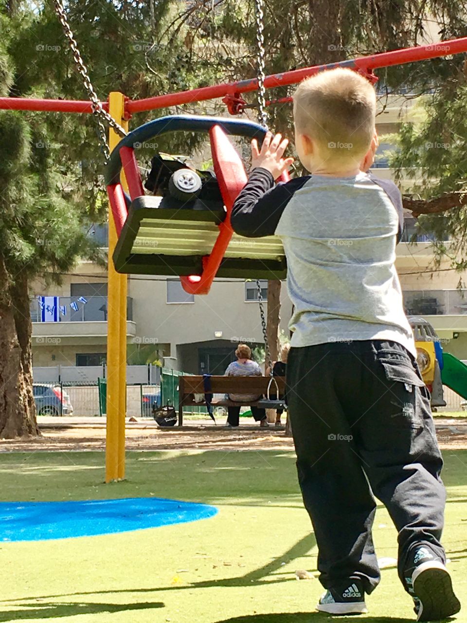 A boy nagging a toy car