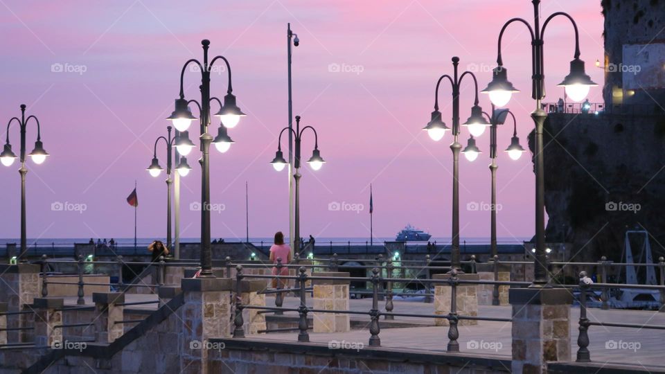 Pink colour sunset. Multiple. Lots of lanterns. Woman in a pink.