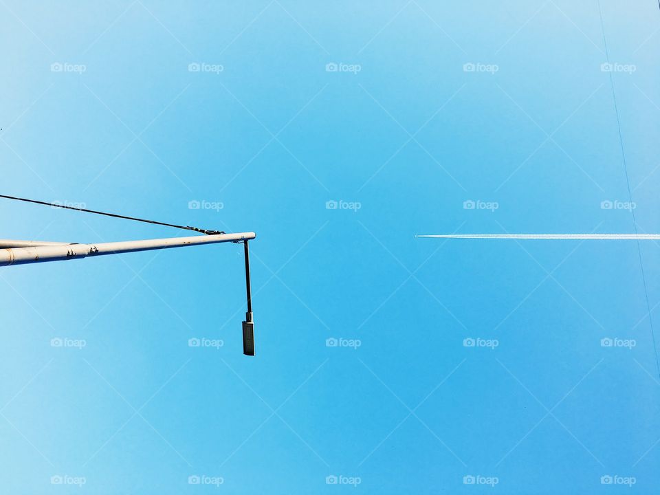 Competition. Symmetrical plane and lantern in the blue sky 