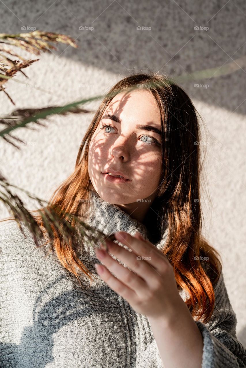 creative woman portrait indoors with light and shadow play