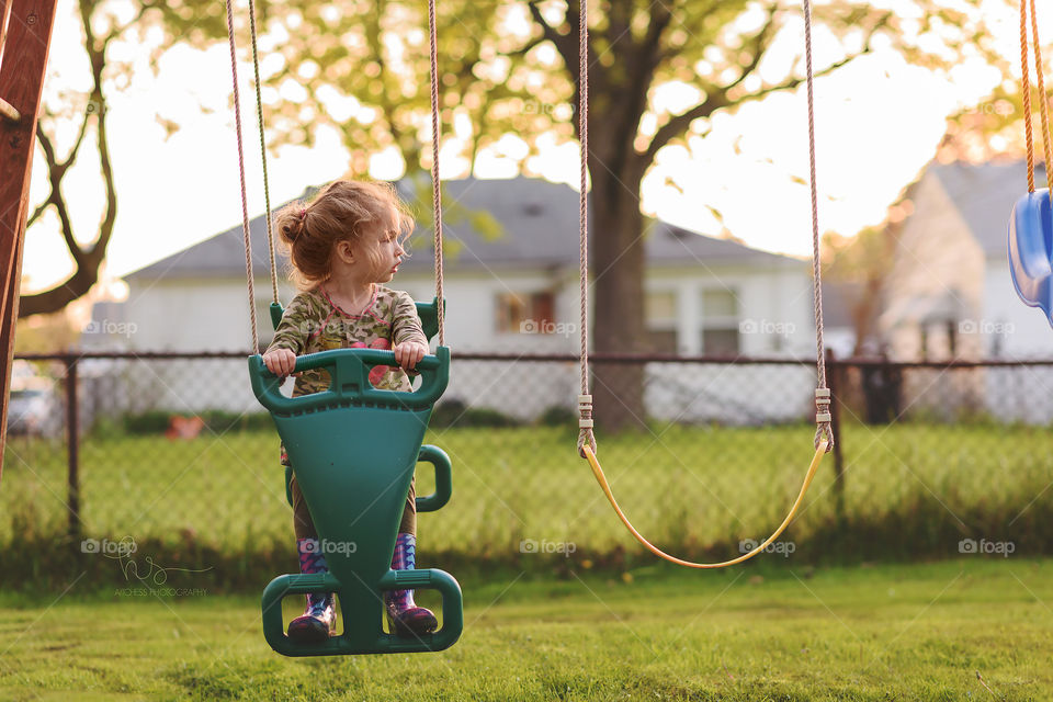 Girl on swing set 