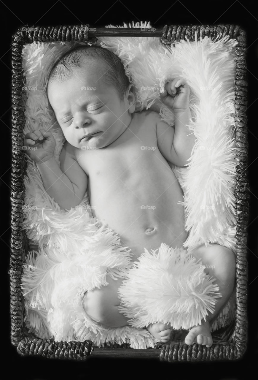 Sleeping baby lying on fur