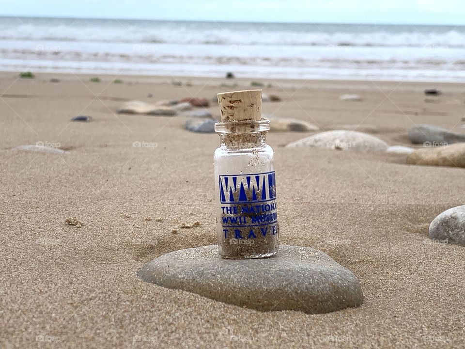The bottle and the stone by the ocean