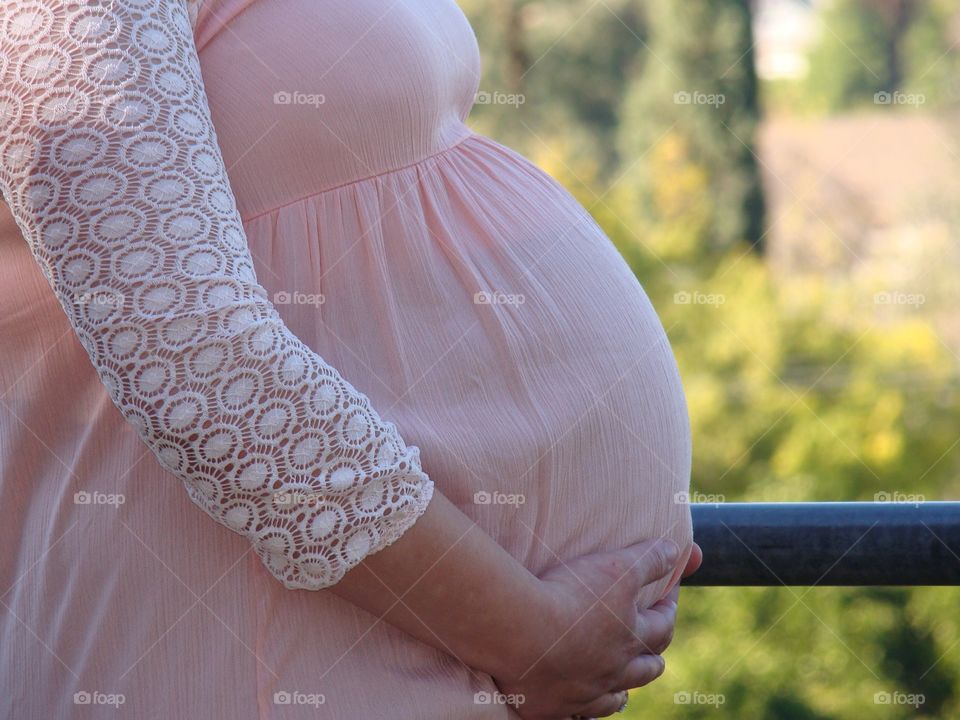 Close-up of pregnant women touching belly