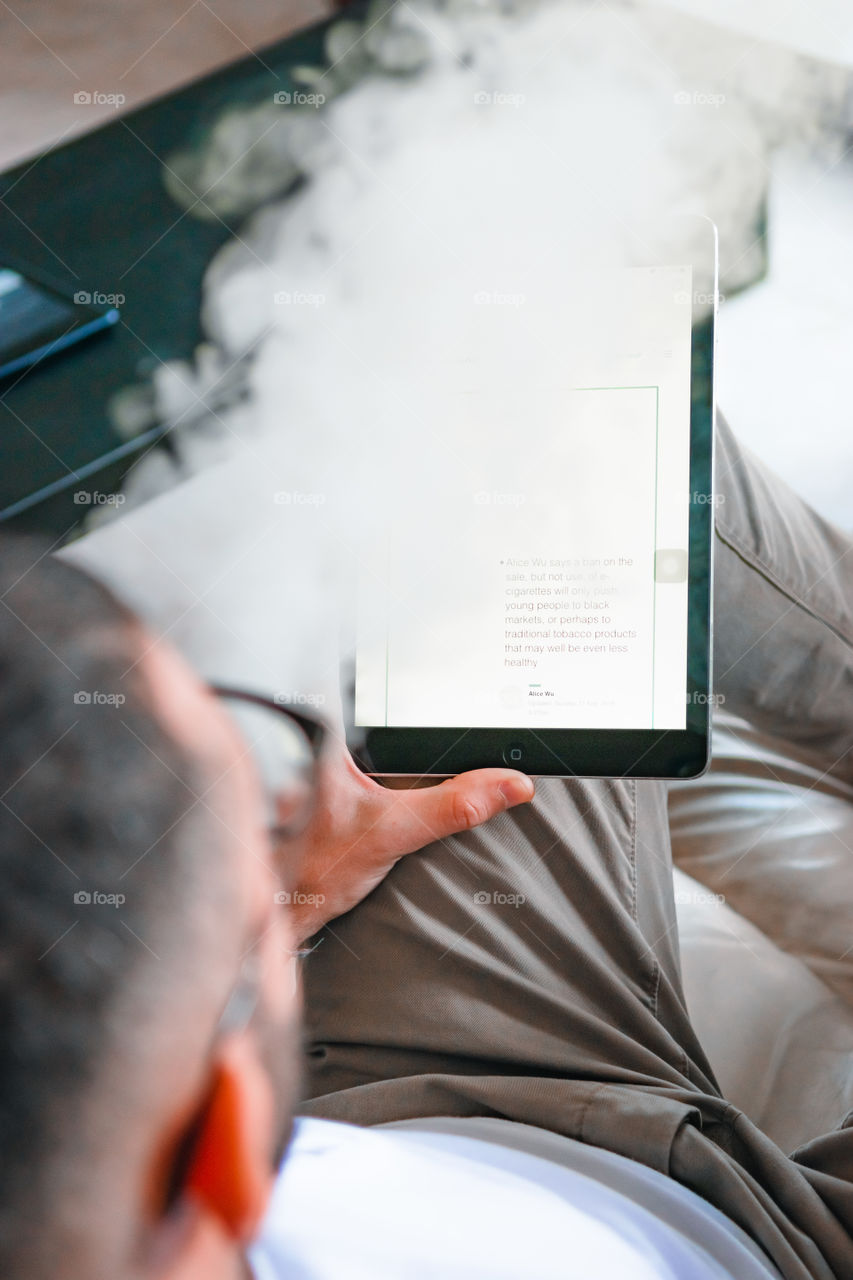 Man smoking while relaxed at home