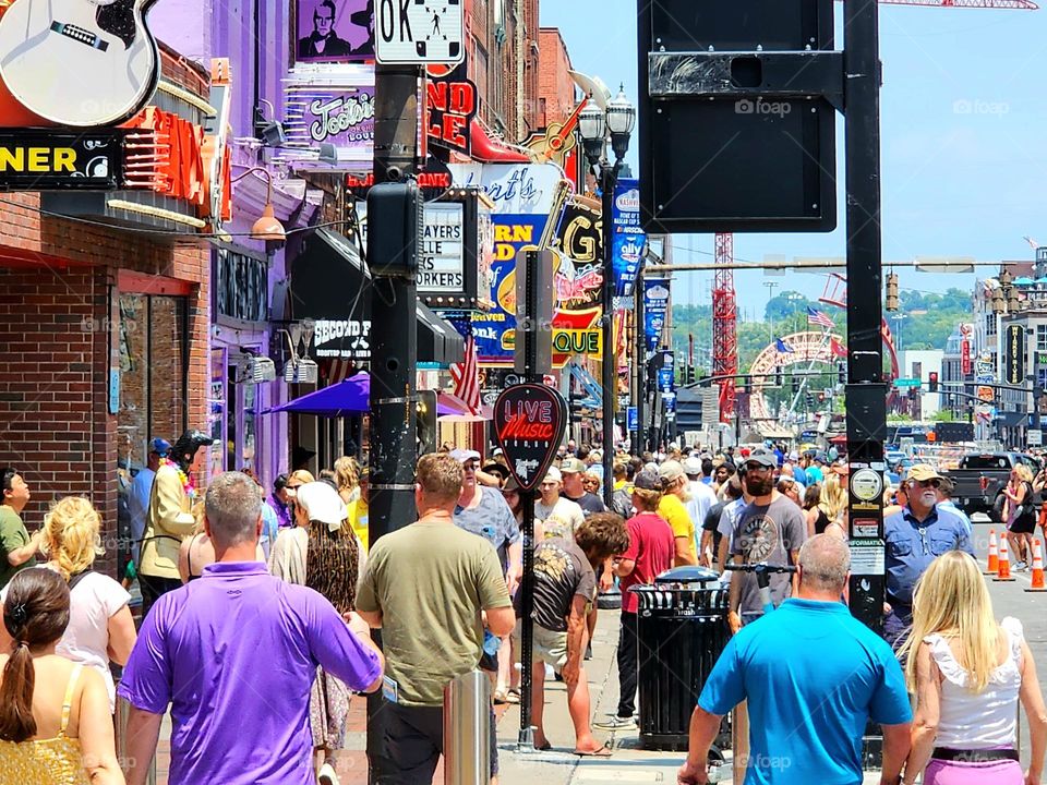 A Saturday afternoon in early summer finds many people taking in the sights and sounds of downtown Nashville