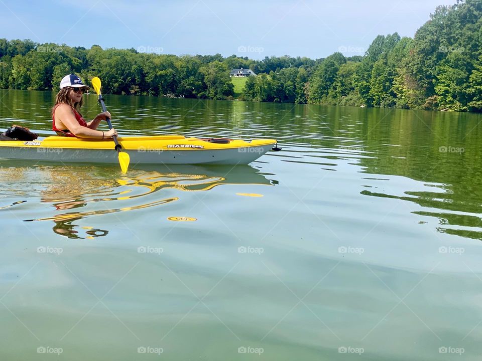 Kayaking adventure on a bright summer day exploring the views across the serene lake