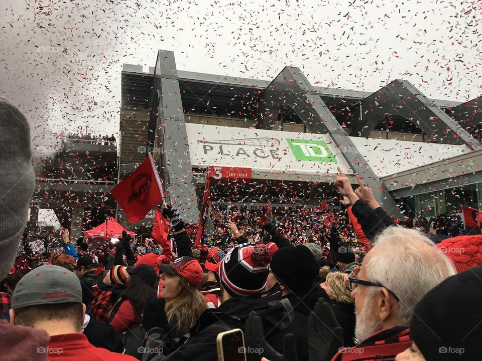 Confetti falls over a crowd during a CFL Redblacks celebration at TD Place at Lansdowne Park in Ottawa, Ontario. 2016.