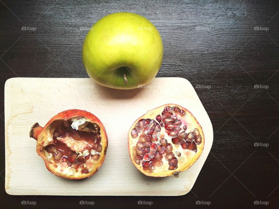 Overhead view of green apple and pomegranate