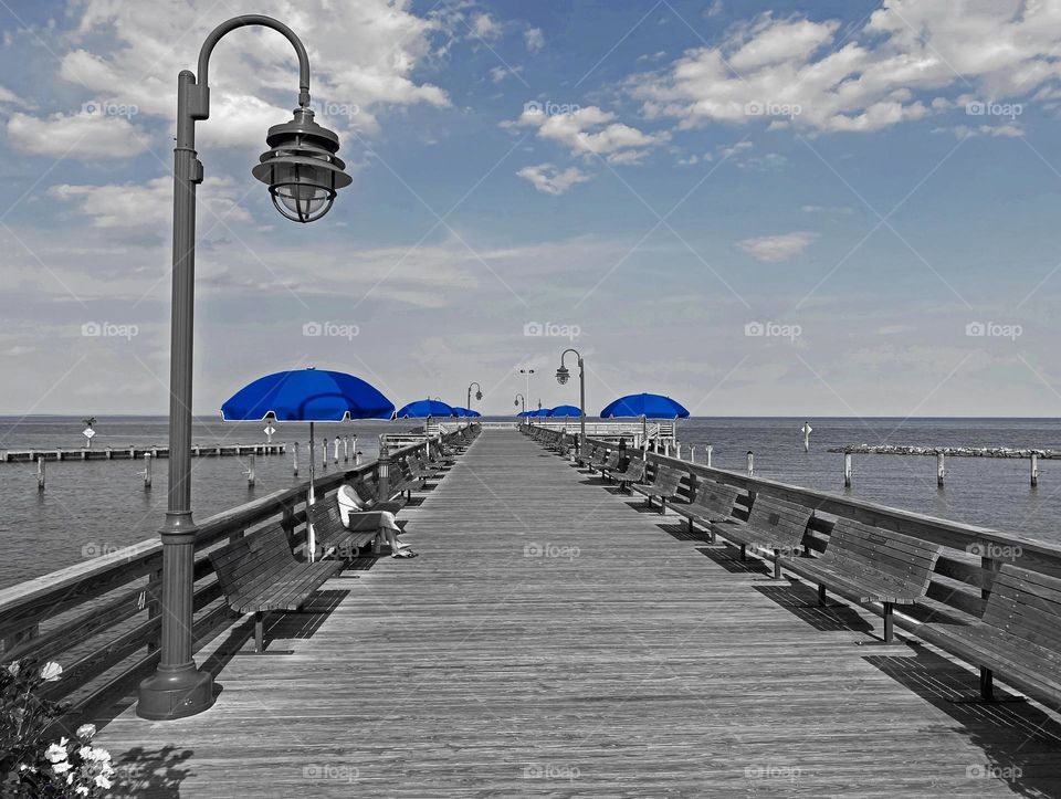 Blue umbrellas on the pier