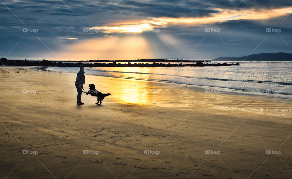 Lady and dog at Silverstrand beach in Galway, Ireland