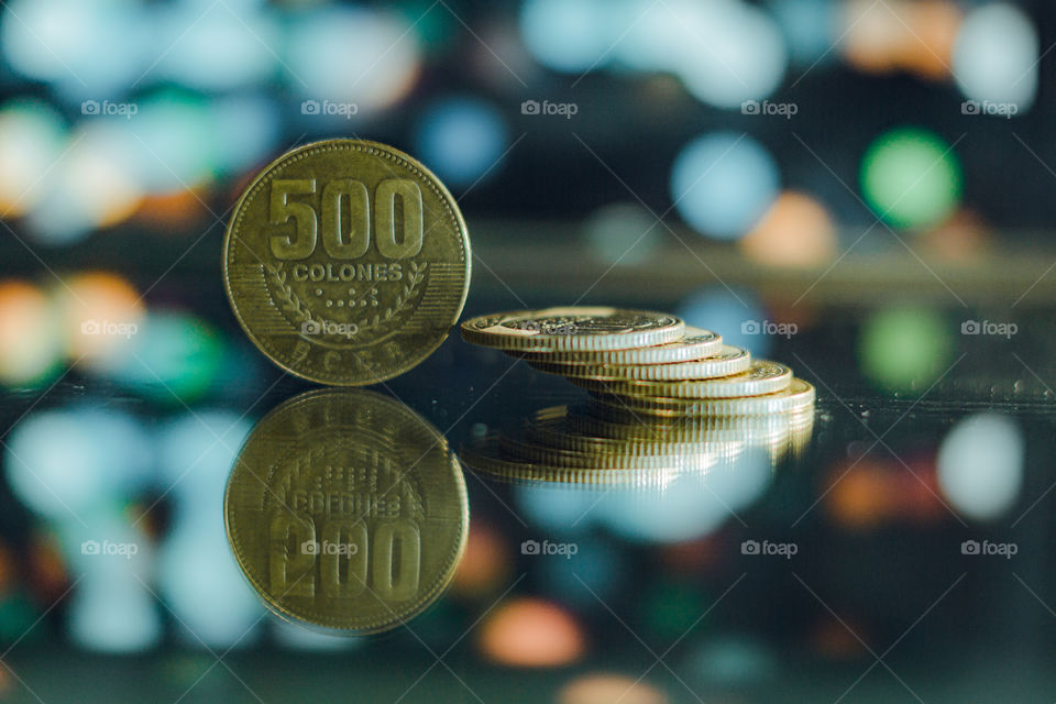 Photography of Costa Rican coins. Coins with reflection and a background bokeh