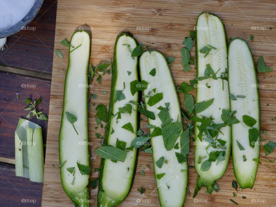 Courgettes zucchini prepared fresh for healthy vegan cooking with herbs