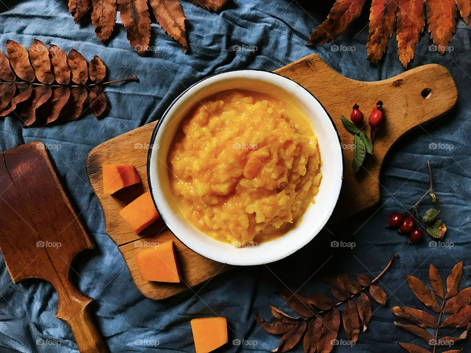 Pumpkin porridge on blue rustic textile background 