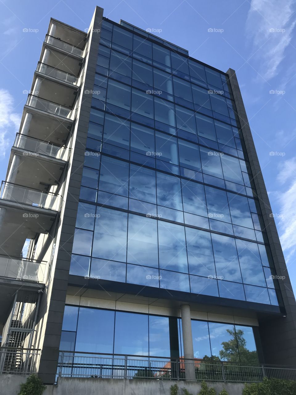 Tall building reflecting the sky and clouds